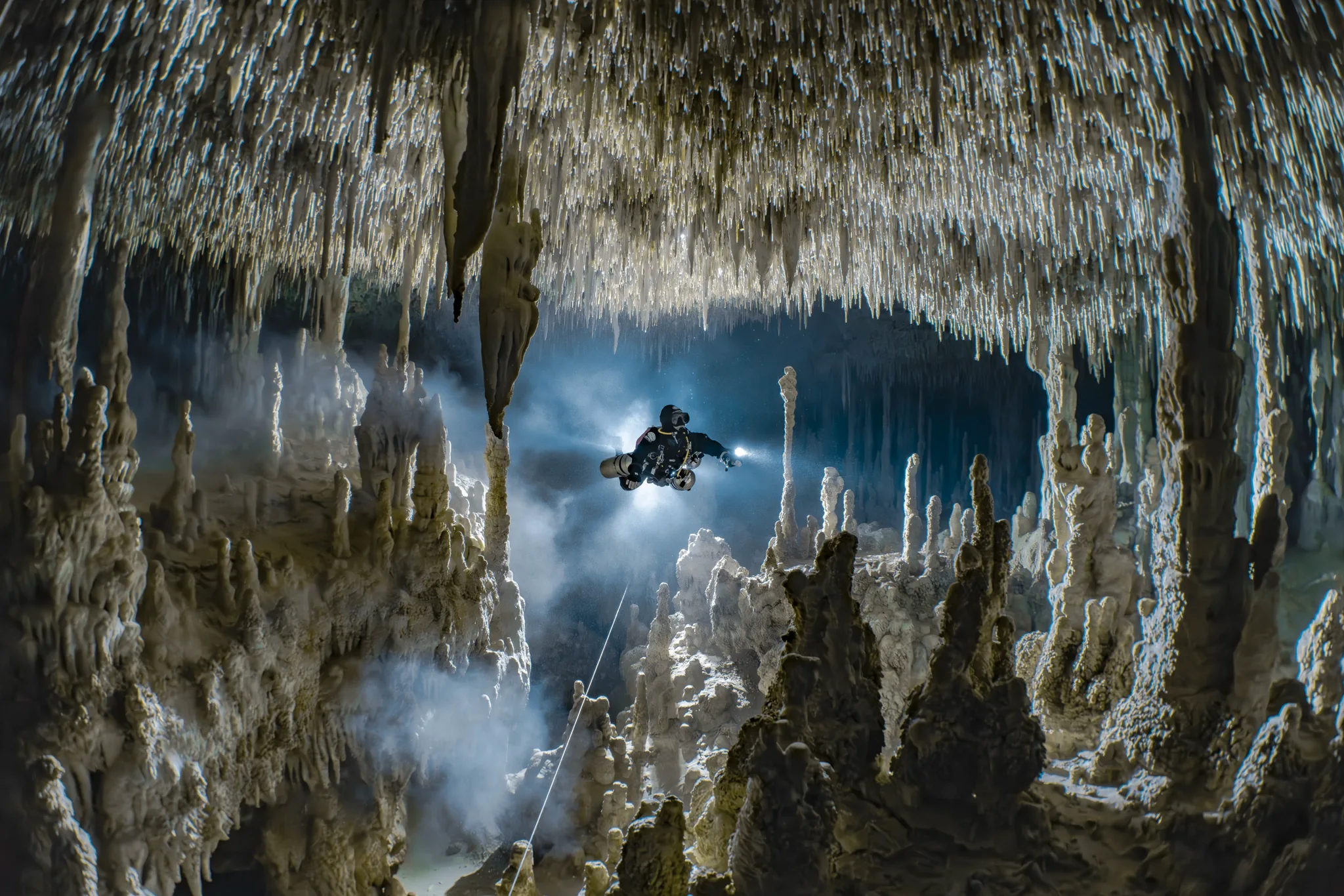 Underwater cave illuminated by beams of natural light